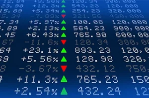 Financial market data and economic indicators displayed on a digital screen.
