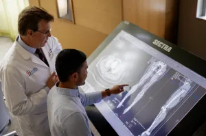 UF healthcare professional reviewing diagnostic medical images with a student.