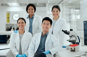 Research team working in a biotechnology laboratory environment.