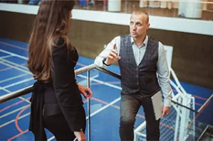 Professional discussion in a sports facility illustrating sport management and leadership concepts.
