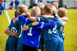 Youth sports team demonstrating teamwork and social interaction in athletics.